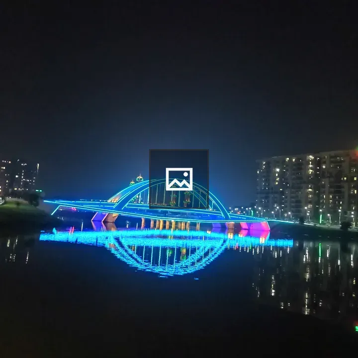 Neon bridge lights reflected in water