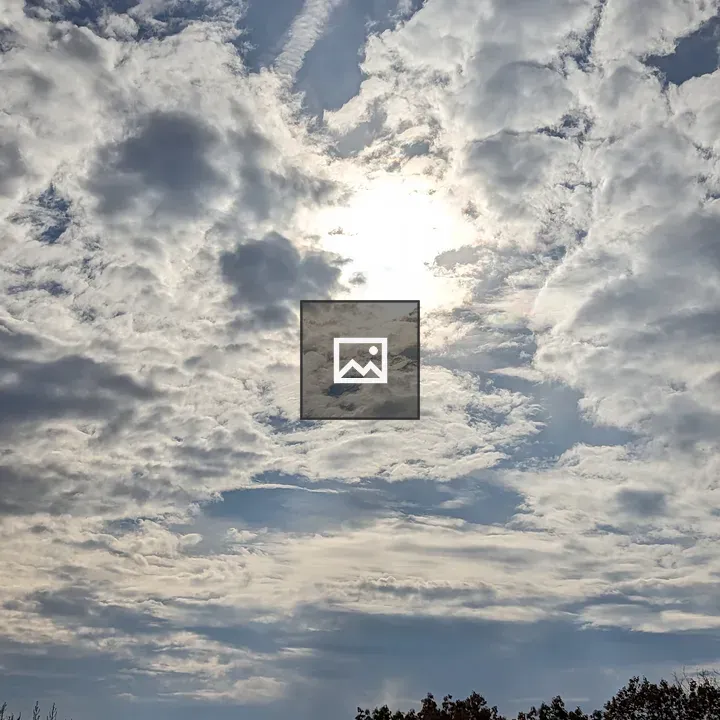 Sunlight Through Clouds Over Trees