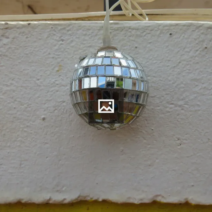 Disco ball against white wall