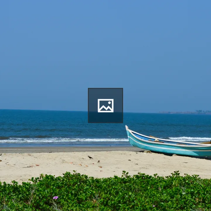 Blue and White Boat on Sand