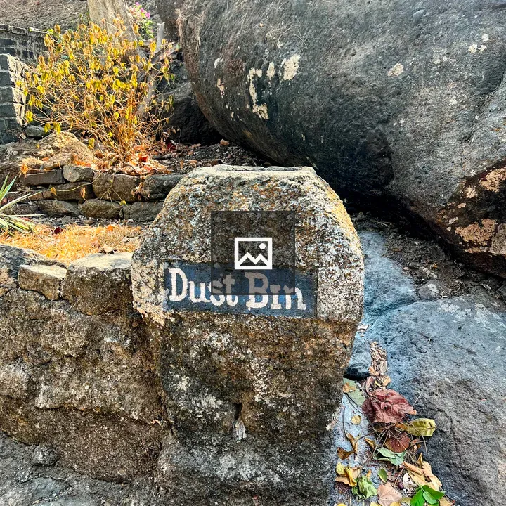 Stone-carved Dust Bin on Rock