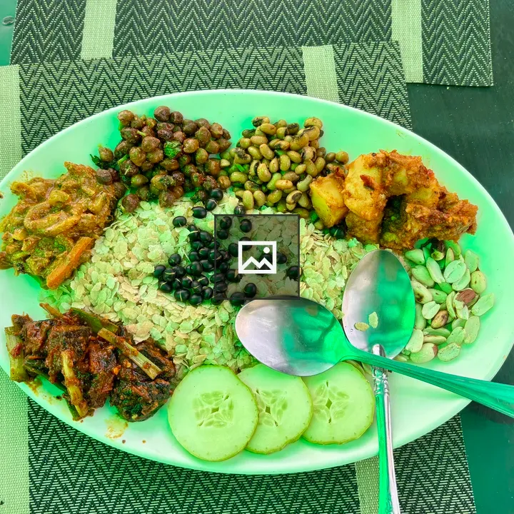 Green plate with Indian snacks