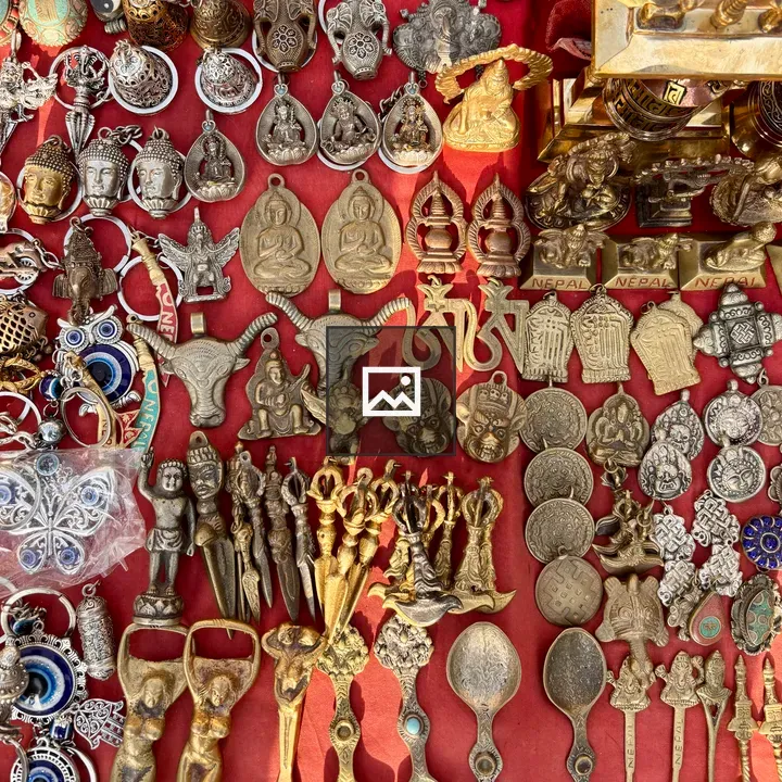 Assorted metal souvenirs on red cloth