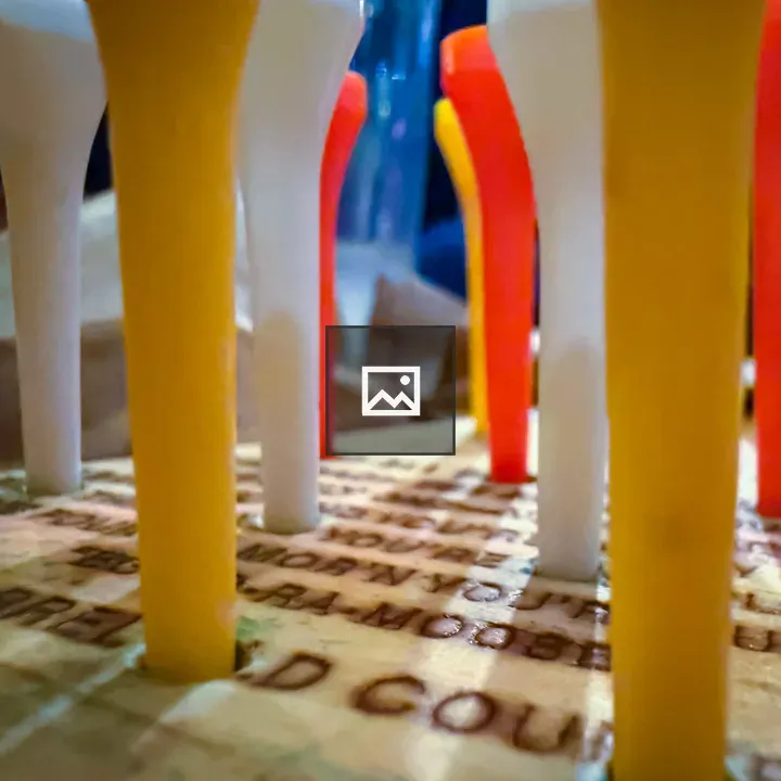 Close-up of golf tees on board