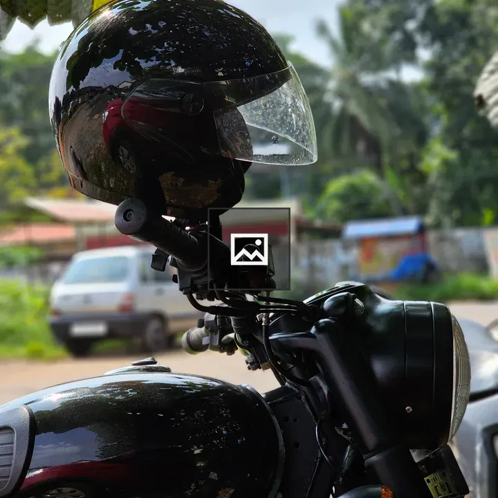 Rider's helmet on motorbike handle