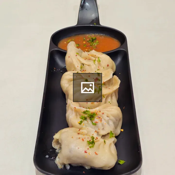 Steamed dumplings in black dish