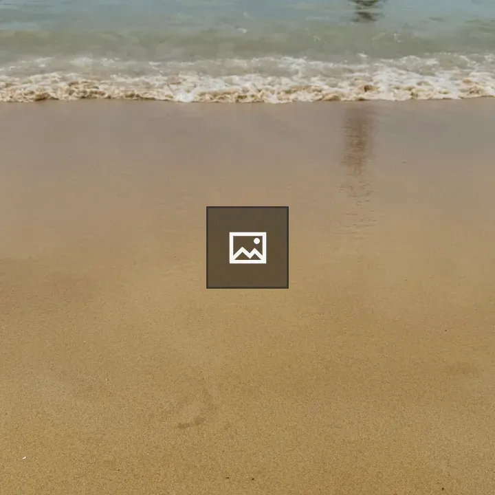 Close-up of sandy beach and waves