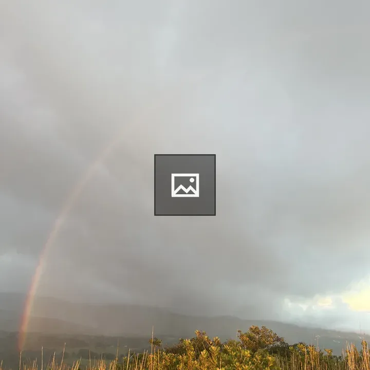 Rainbow over green hills