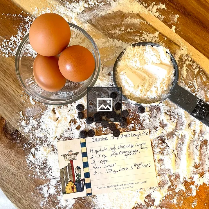 Eggs and chocolate chips on cutting board