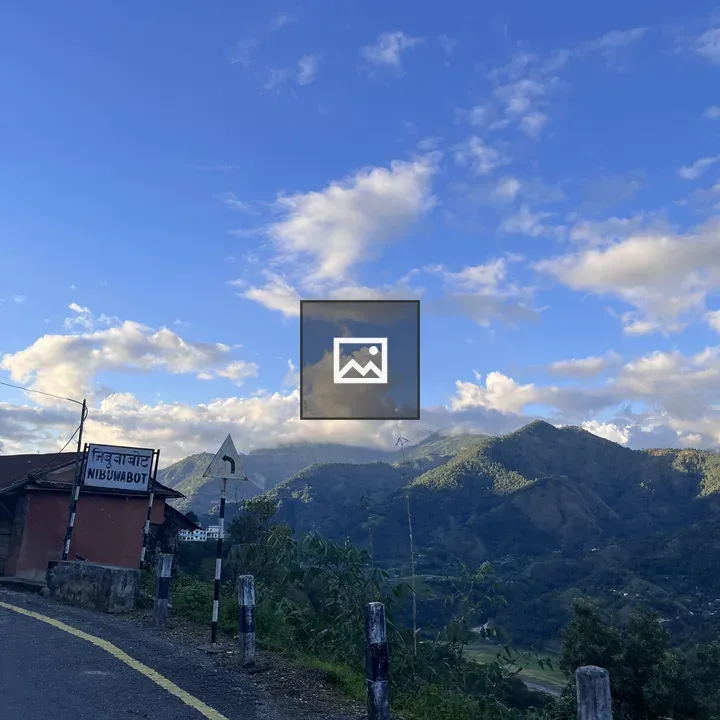Mountain road with curved sign