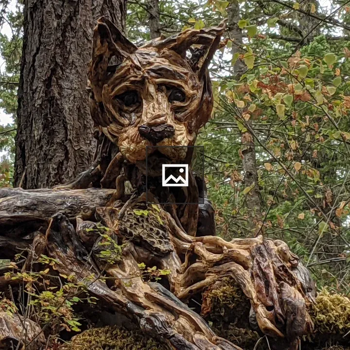 Driftwood cougar sculpture on trail