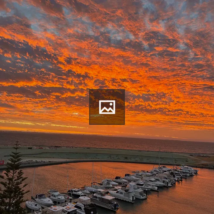 Sunset over marina with boats