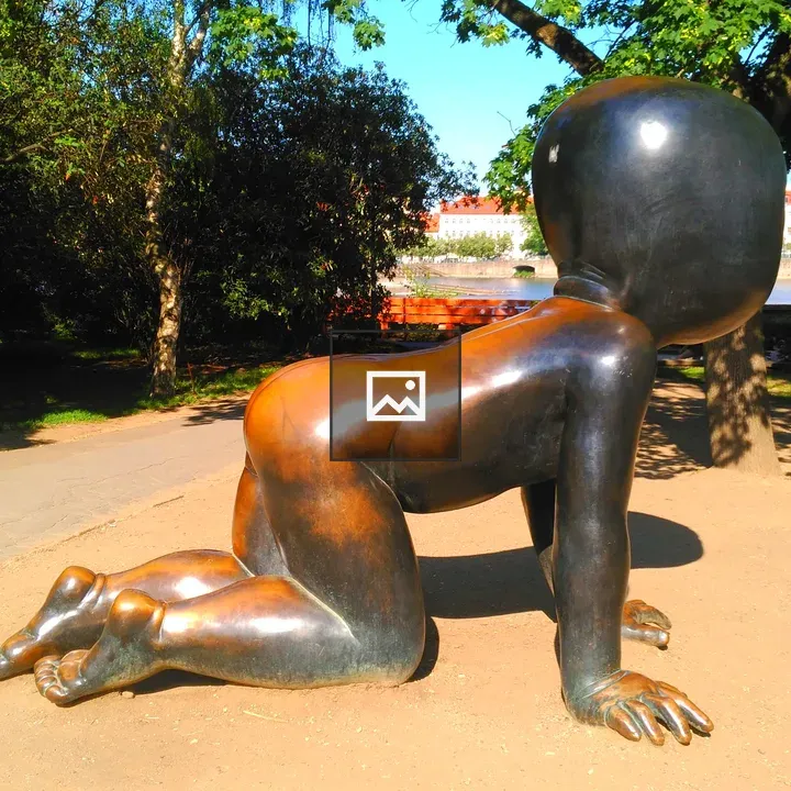 Brass statue of a crawling baby