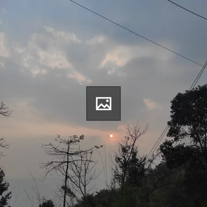 Hazy Sunset Behind Clouds