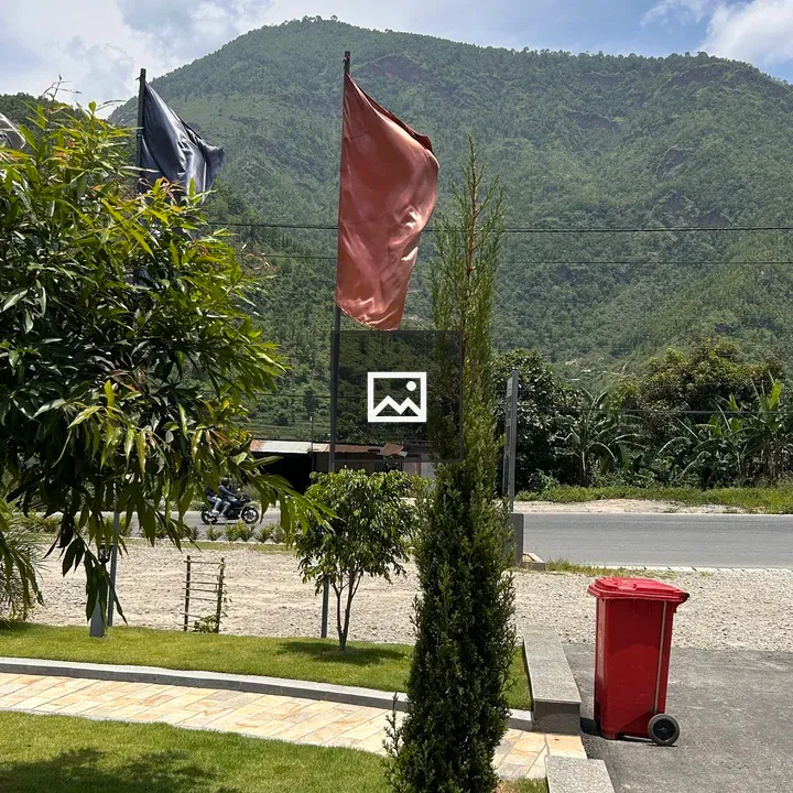Flags fluttering in green mountains