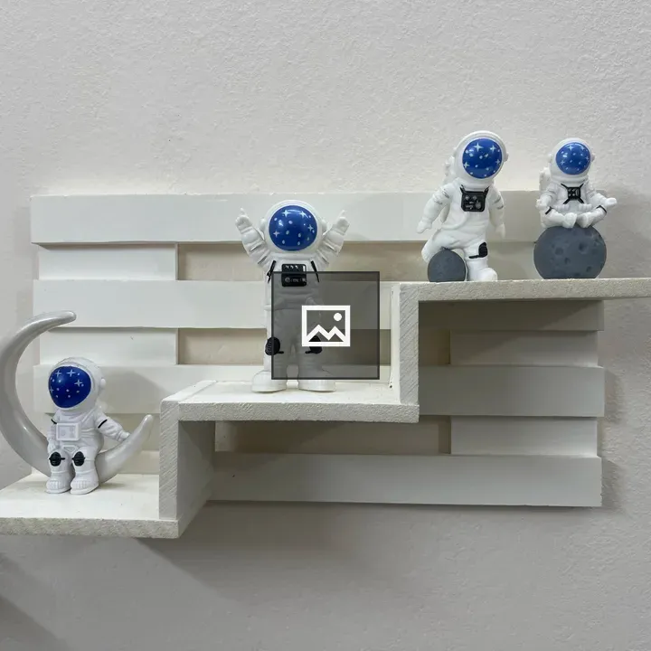 Four astronaut figures shelf scene