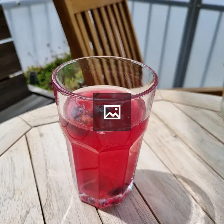 Glass with magenta kombucha