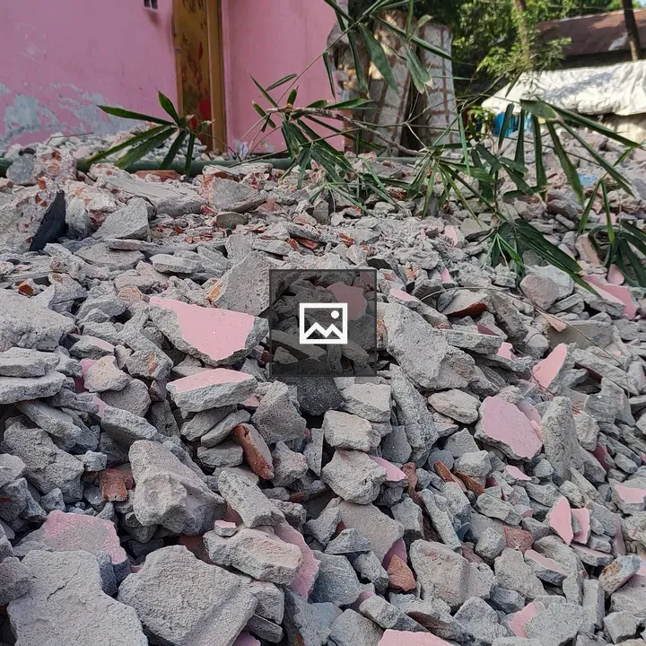 Pile of rubble with pink wall