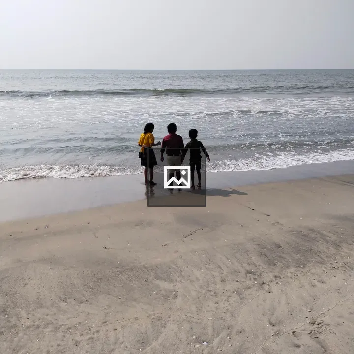 Three children on a windy beach