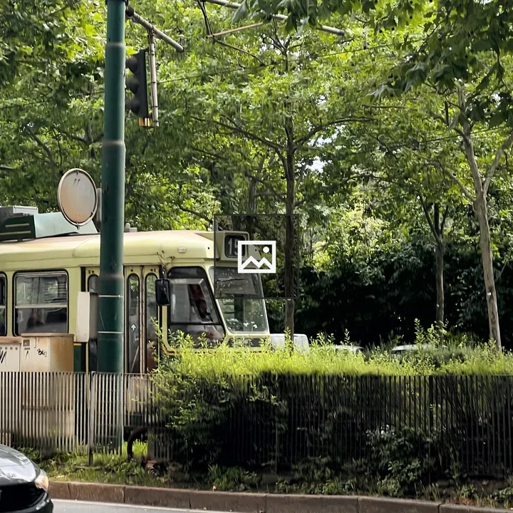 Green tram at station