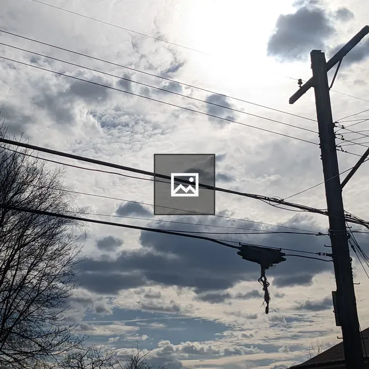 Sky with clouds and a telephone pole