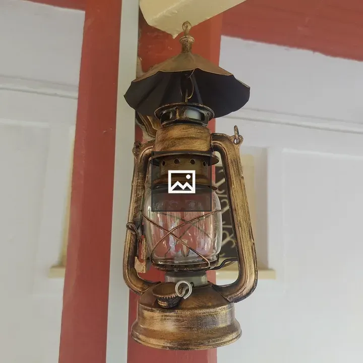 Vintage oil lantern hangs from ceiling