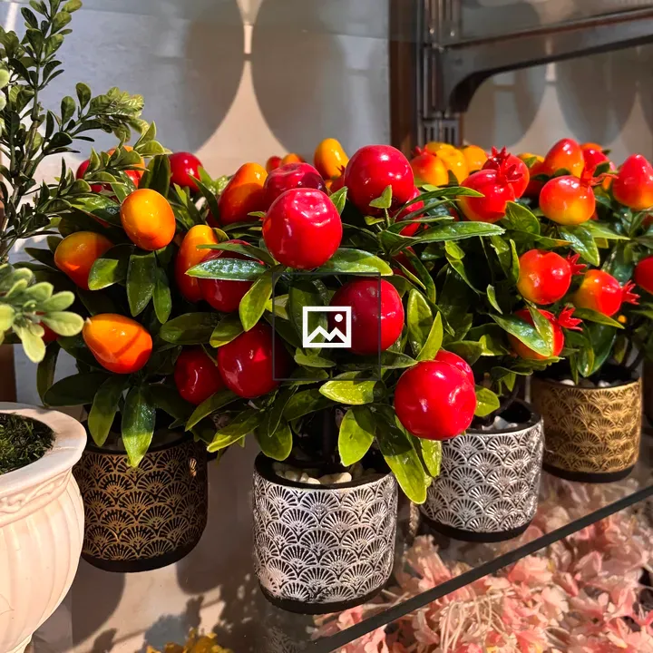 Pots of artificial plants on shelf