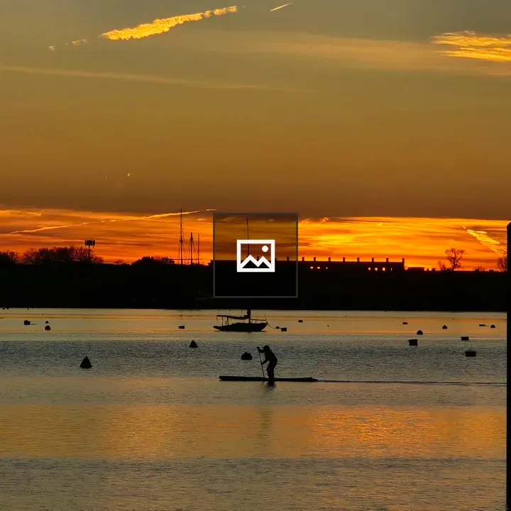 Silhouetted Paddleboarder at Sunset