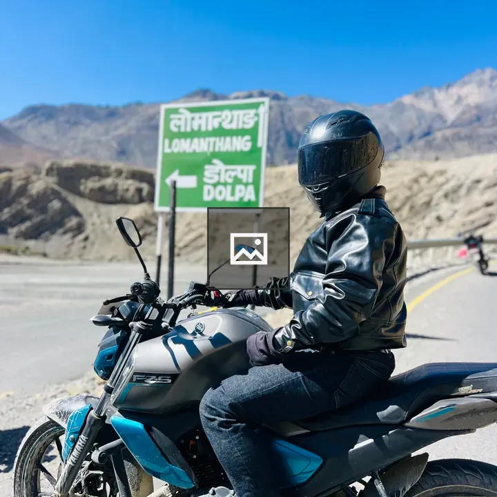 Person on racing bike with road sign
