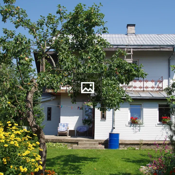 White two-story house with garden