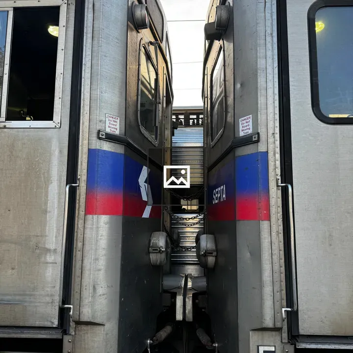 Two SEPTA rail cars from below