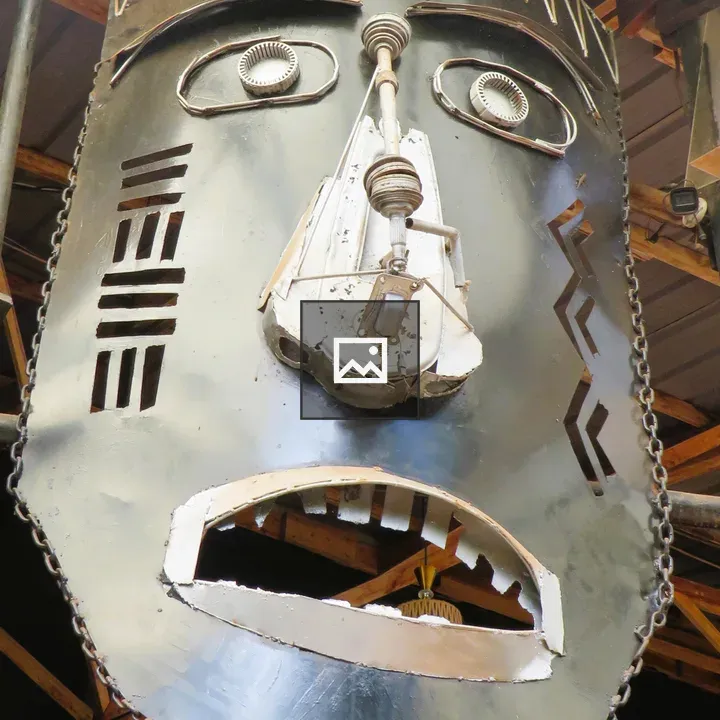 Dark metal face sculpture