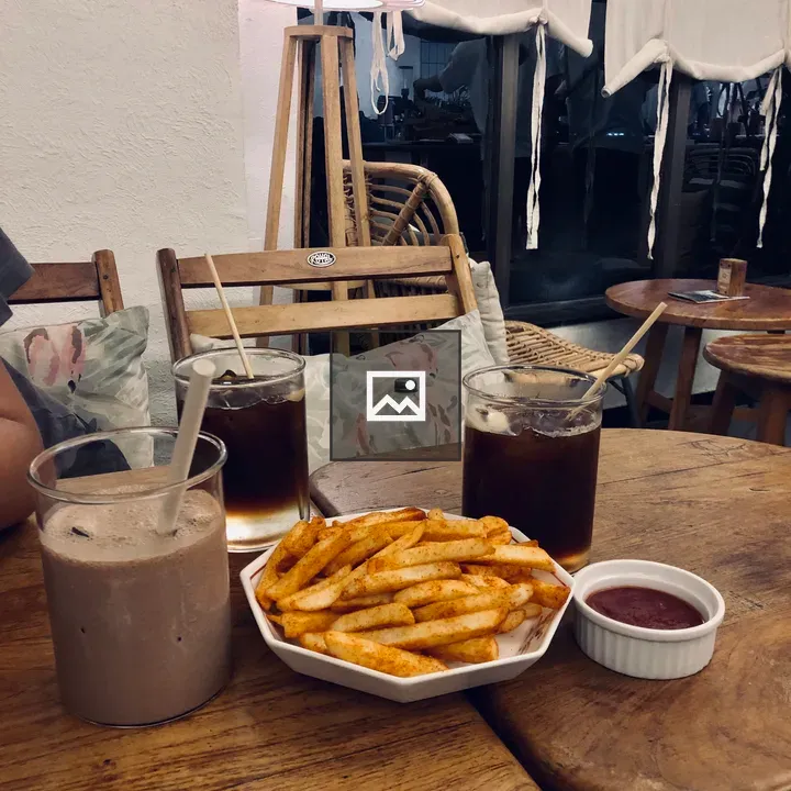 Table with iced coffee and fries