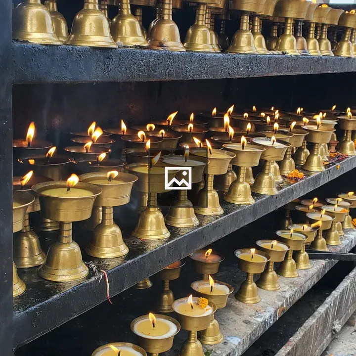 Burning butter oil lamps at Golden Temple Kathmandu