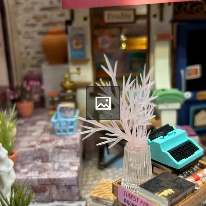 Room interior in miniature with plant and typewriter