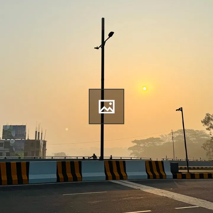 Paved Road with Bridge at Sunrise
