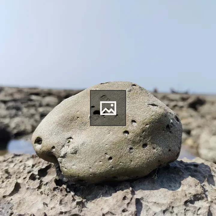 Small rock stand on a big rock