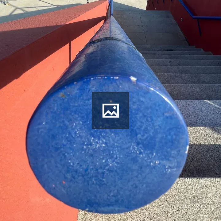 Staircase with blue handrail