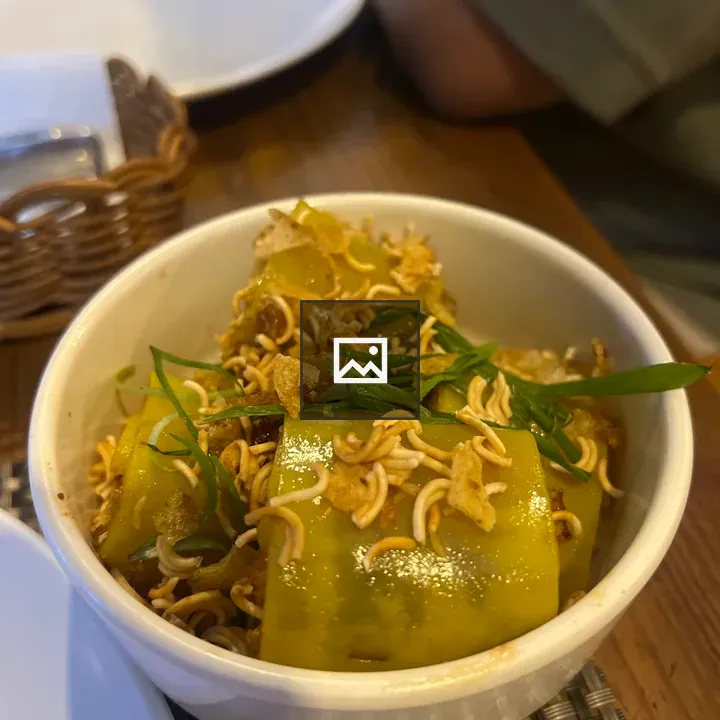 Bowl with fried noodles and green onions