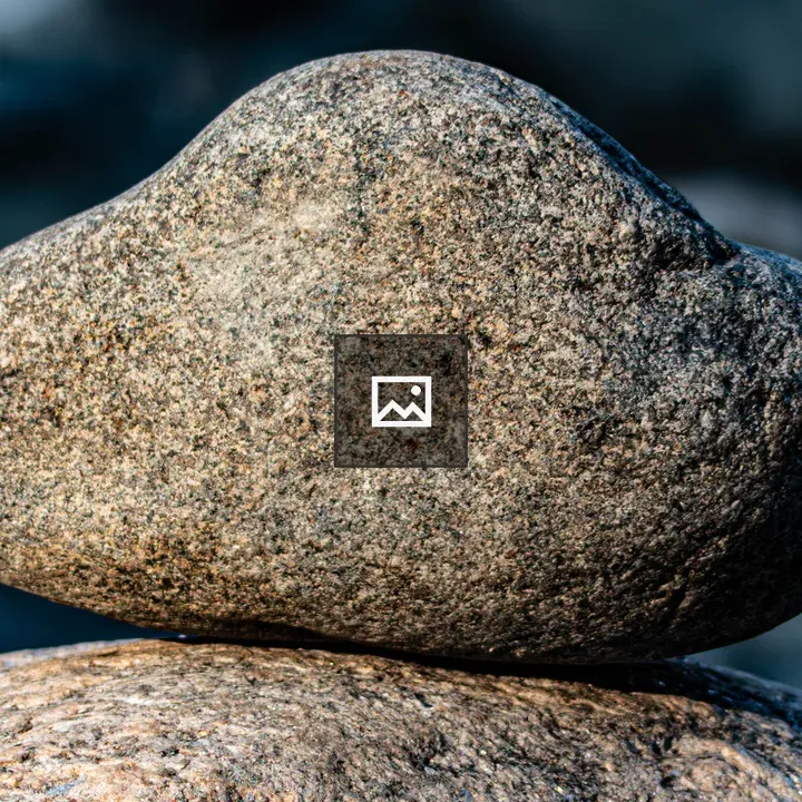 Stone balanced on large rock