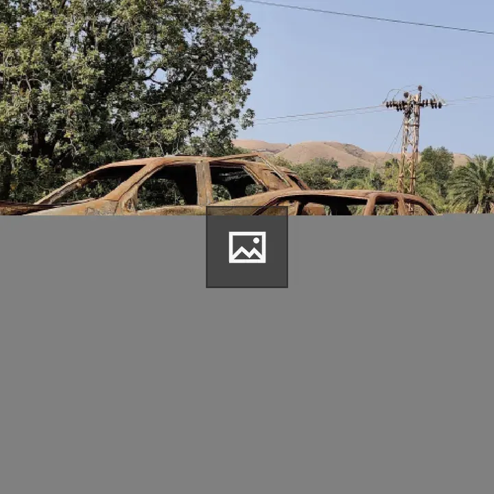 Two cars burned beside rocky soil