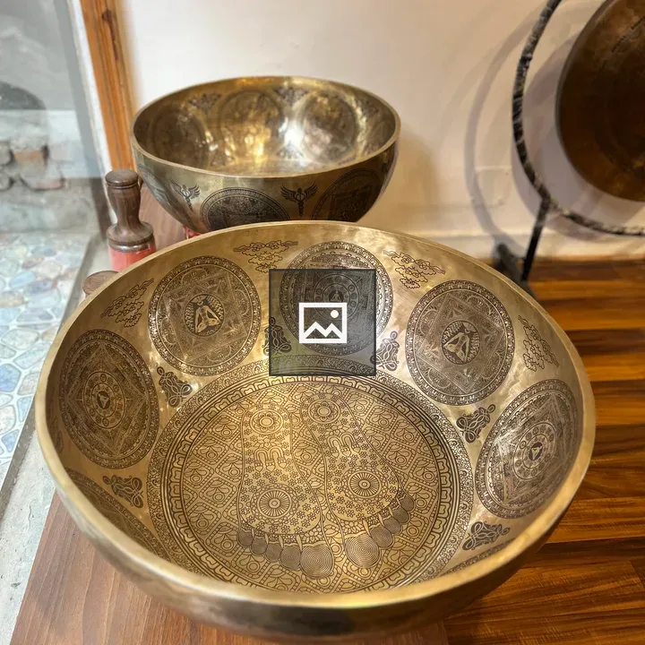 Brass singing bowls on wood