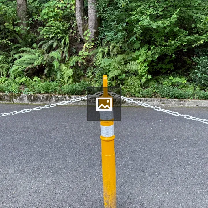 Yellow reflective bollard at garden entrance