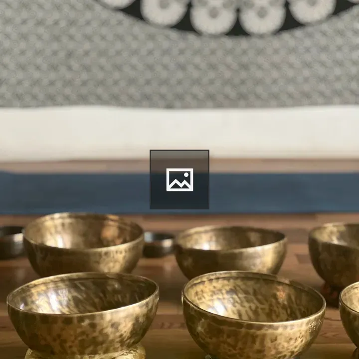 Golden singing bowls on wood