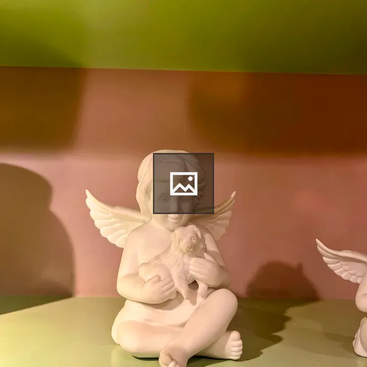 Winged angel figurine with dog