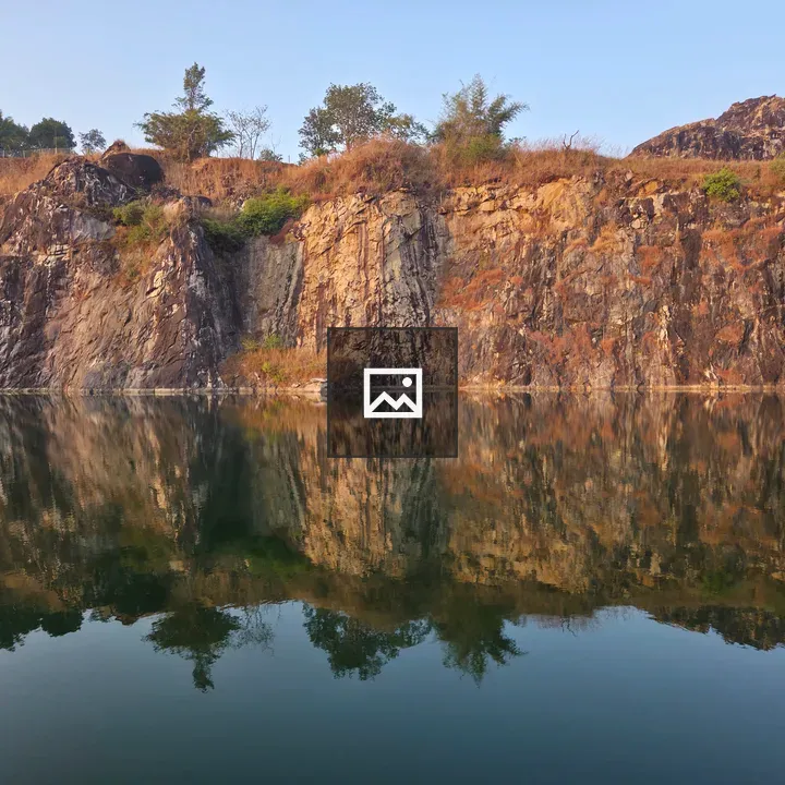 Rocky cliff rising from water