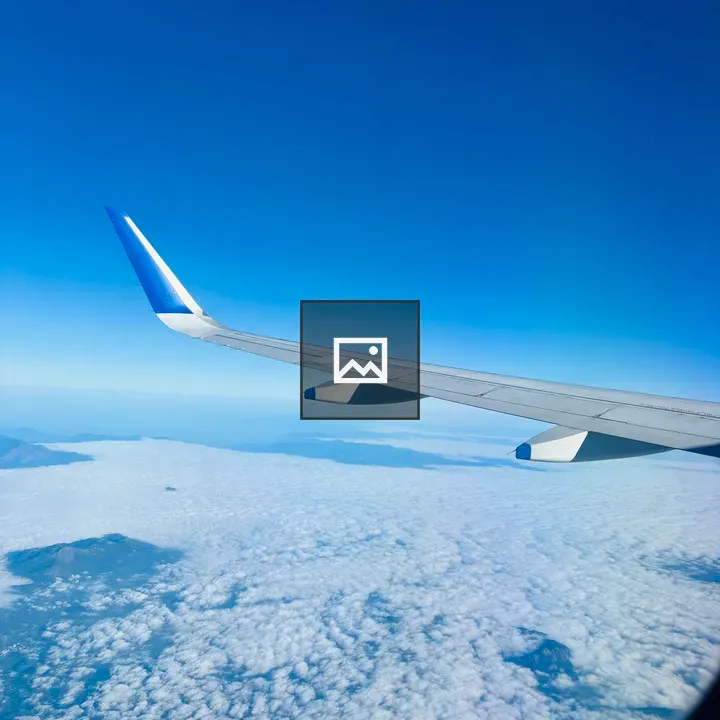 Airplane Wing Over Clouds