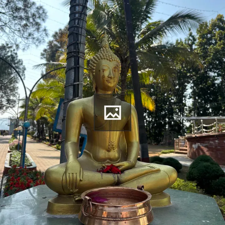 Golden Buddha Statue in Green Setting