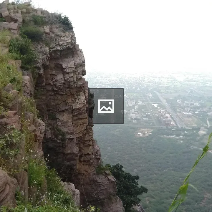 Rocky cliff edge with vegetation
