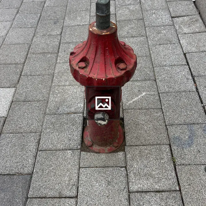 Red fire hydrant on sidewalk